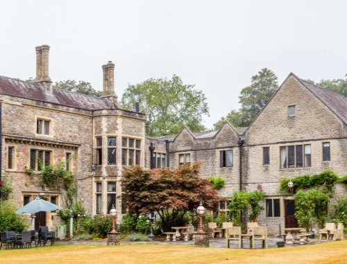 Tables and chairs outside a medieval manor